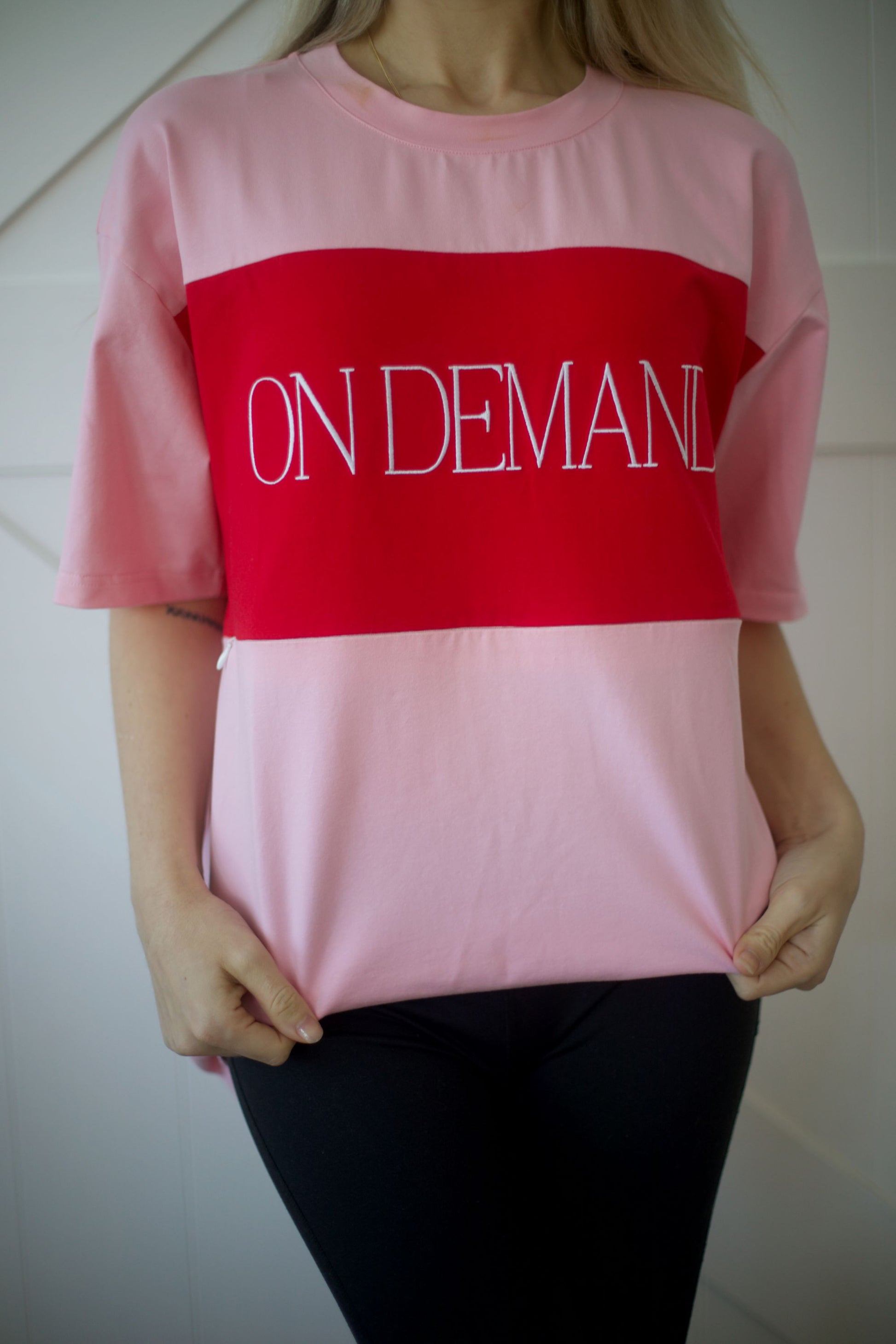 Close-up of the On Demand embroidered logo panel on the pink breastfeeding t-shirt.